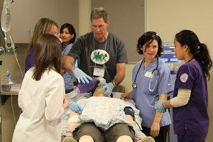 Interprofessional health sciences students and facilitator participating in a simulation at the University of Washington's WWAMI Institute for Simulation in Healthcare