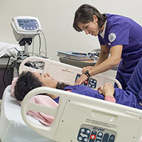 UW School of Nursing faculty and researcher practicing simulation.